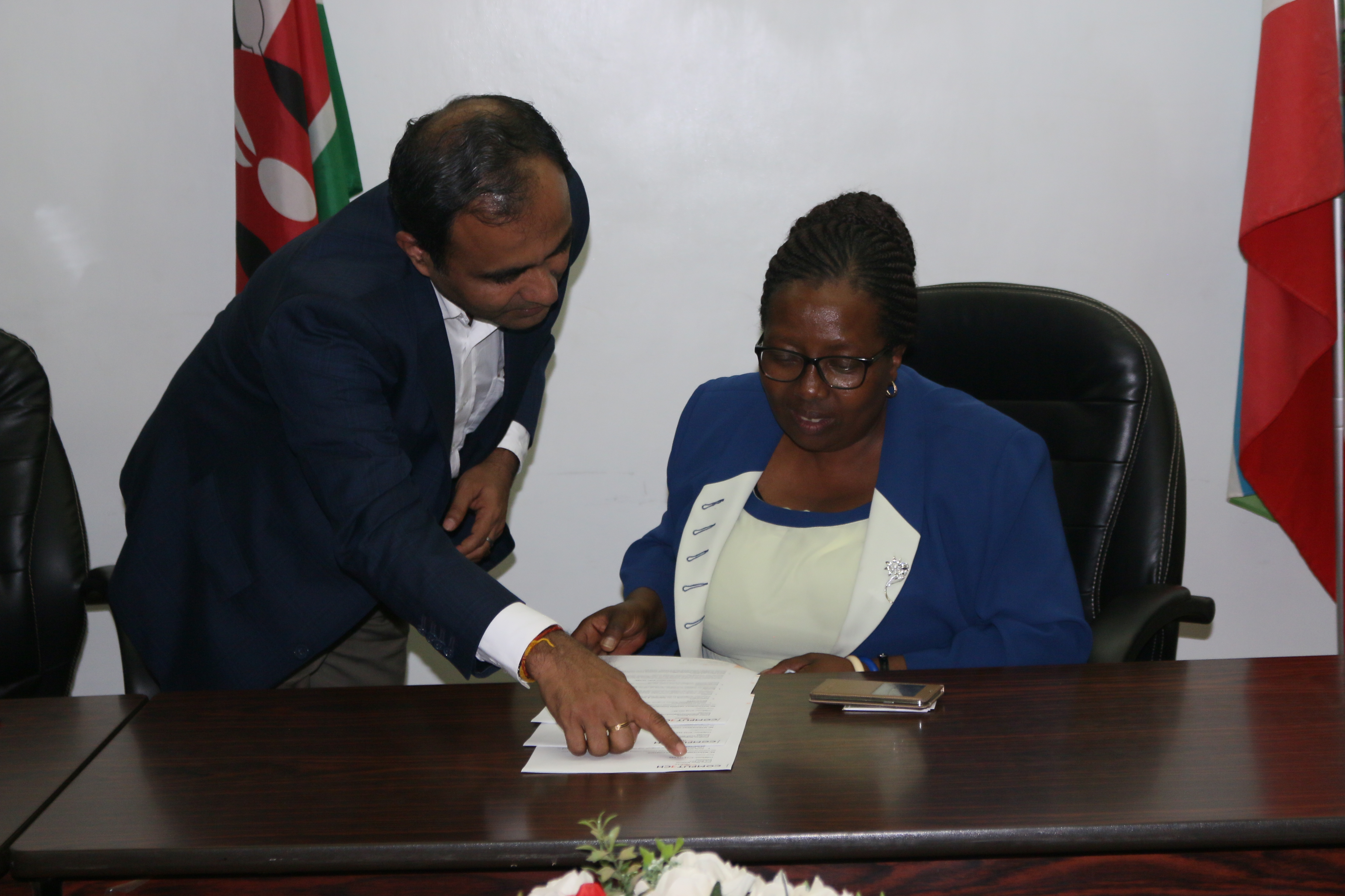 Vice Chancellor Prof. Victoria Ngumi confers with Computech's Santhosh Kumar at the meeting