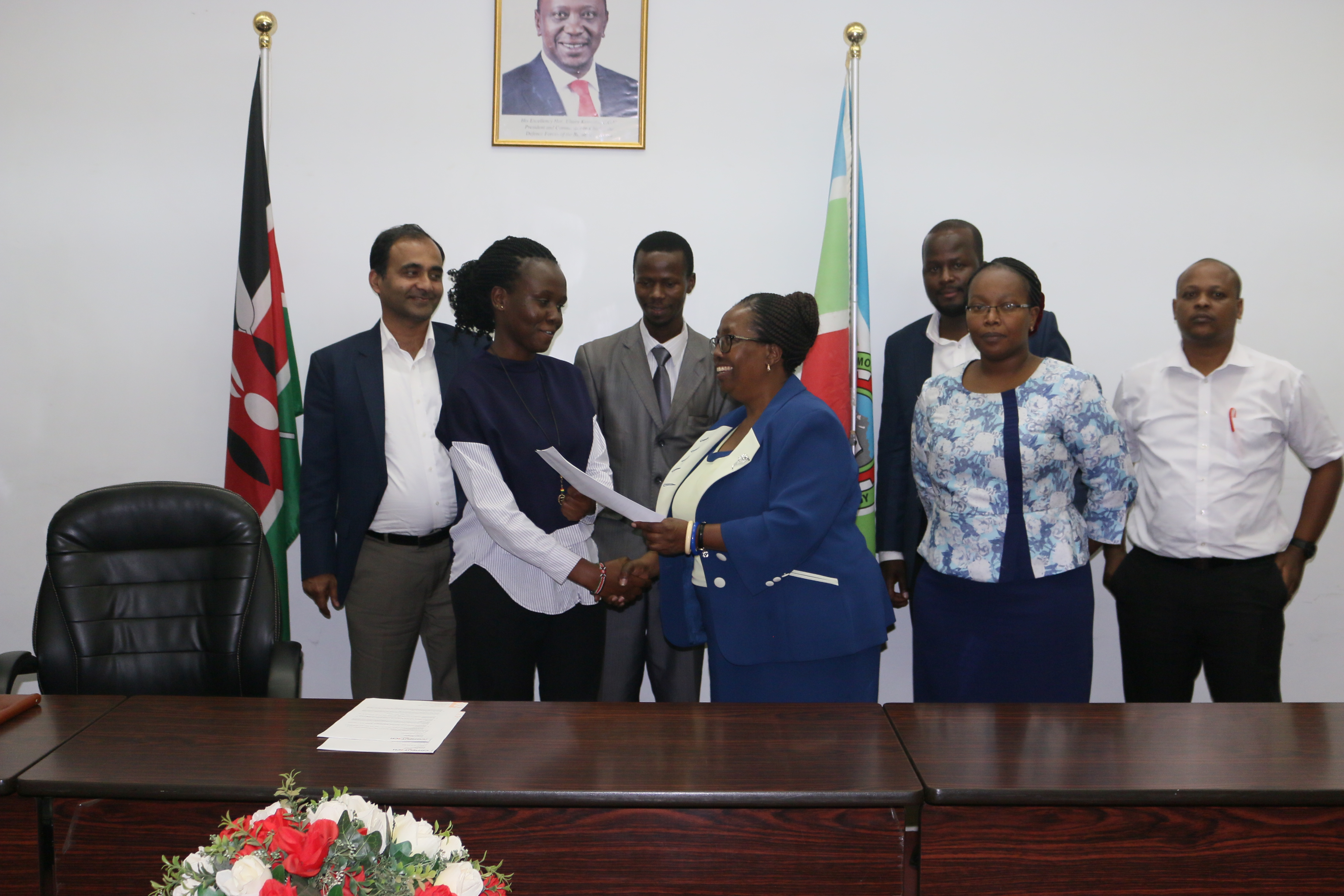 VC Prof. Victoria Ngumi presents a certificate to one of the students, Ms. Lesli Bonyo.